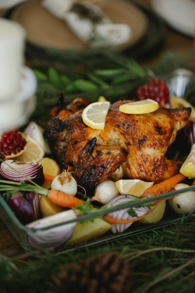 Delicious roast chicken surrounded by fresh vegetables, perfect for a holiday feast.