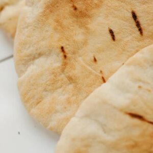 Close-up of freshly baked pita bread showcasing its texture and crispness.